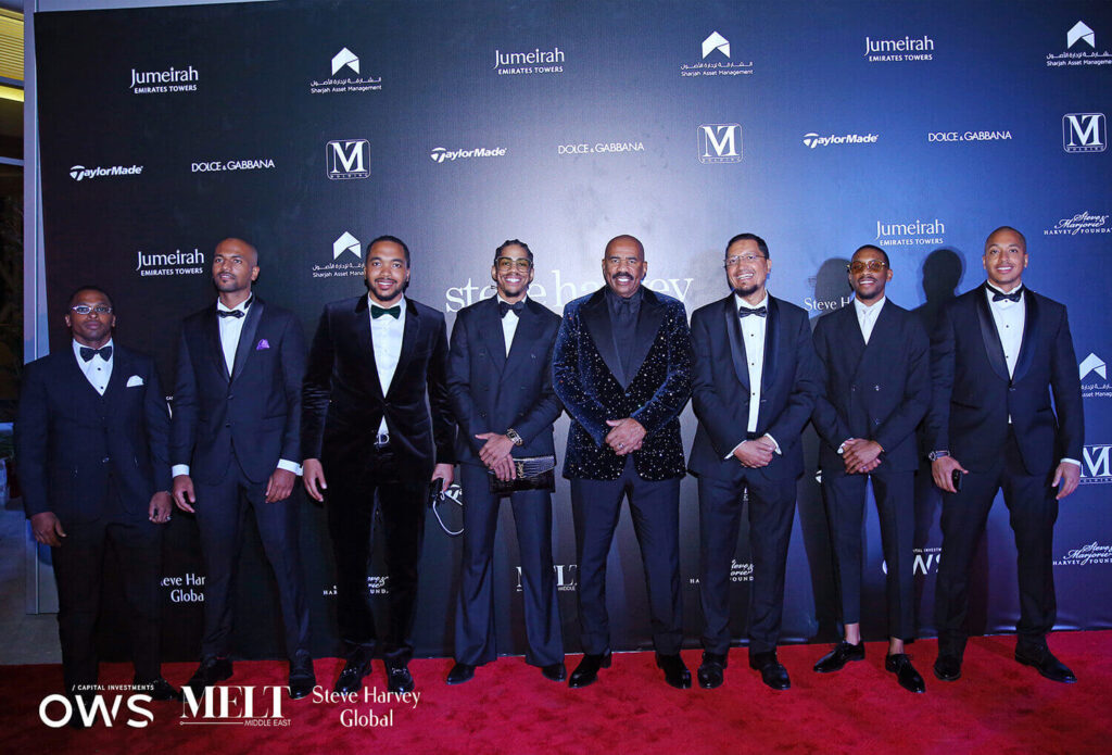 Guests pose on the red carpet with Steve Harvey